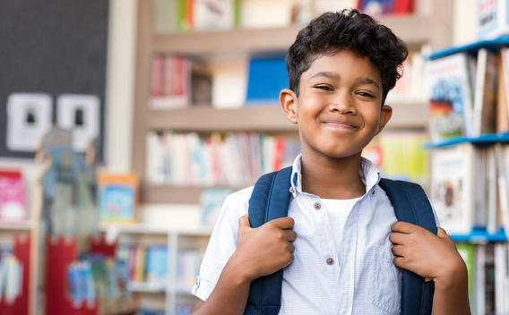 Young student smiling in school library