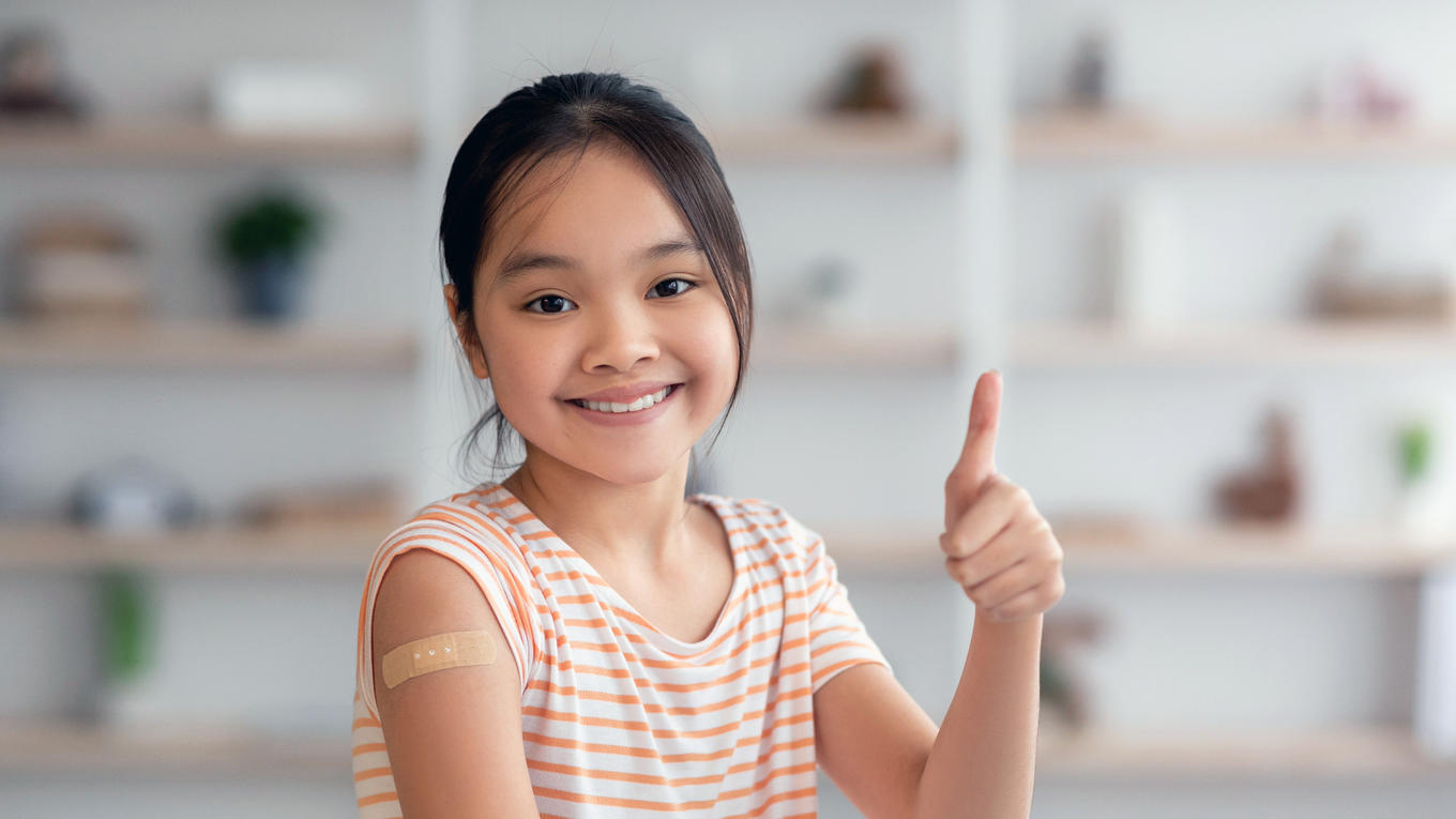 Girl smiling after getting vaccinated