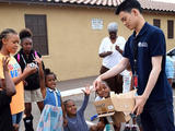 AmeriCorp - youth member serving goods to a family