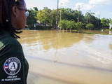 AmeriCorps - member looking out over flooded street